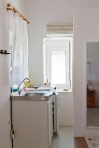 a kitchen with a sink and a window at Spiros Apartments in Livadia