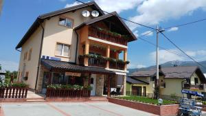 a building with balconies on the side of it at Guest House Mijić in Korenica