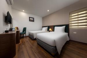 Voodi või voodid majutusasutuse Hanoi Vista Hotel toas