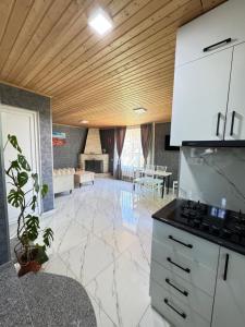 a kitchen with a counter and a living room at Buo's guest house in Borjomi