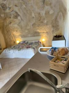 a kitchen with a sink and a bed in a room at Agorà nei sassi in Matera +32 photos