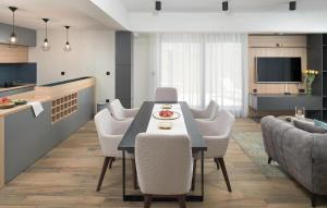 a kitchen and living room with a table and chairs at Awesome Home In Makarska With Sauna in Makarska