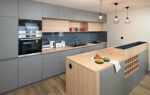 a kitchen with a counter with a bowl of fruit on it at Awesome Home In Makarska With Sauna in Makarska