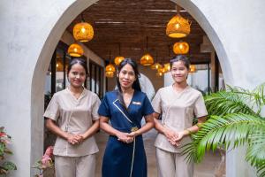a group of three women standing next to each other at SeaTara Resort in Ko Phangan