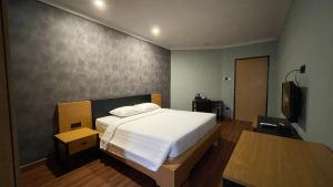 Postel nebo postele na pokoji v ubytování LPP Garden Hotel