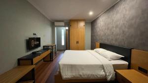Postel nebo postele na pokoji v ubytování LPP Garden Hotel