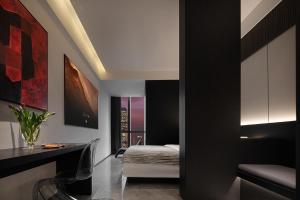 a bedroom with a bed and a desk in a room at Enji M Hotel-Chongqing Shapingba High-speed Railway Station Three Gorges Square in Chongqing