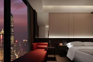 a bedroom with a bed and a view of a city at Enji M Hotel-Chongqing Shapingba High-speed Railway Station Three Gorges Square in Chongqing