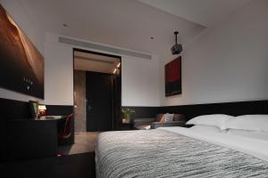 a bedroom with a large bed and a living room at Enji M Hotel-Chongqing Shapingba High-speed Railway Station Three Gorges Square in Chongqing