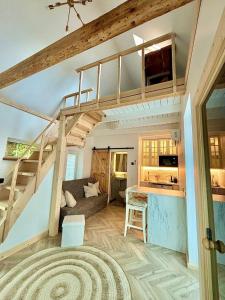 a living room with a loft bed and a kitchen at Charming Cottage - Sauna - Central Location in Šiauliai