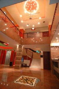 a lobby with a staircase and a rug on the floor at Hotel Olympion in Katerini