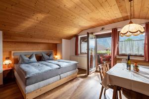 a bedroom with a bed and a dining room with a table at Appartementhaus Ederegger in Ebbs