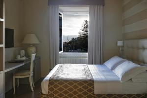 Postel nebo postele na pokoji v ubytování Lolli Palace Hotel