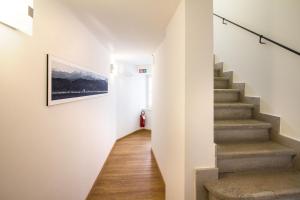 a hallway with stairs and a painting on the wall at Hotel All'Arco in Trieste