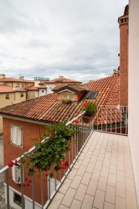 a balcony of a building with red tile roofs at Hotel All'Arco in Trieste