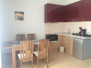 a kitchen with a table and chairs and a microwave at Catherine Villas in Maronia