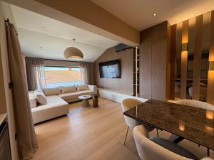 a living room with a couch and a table at Pansion Katarina Krk in Malinska