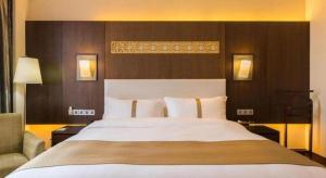 Voodi või voodid majutusasutuse Datong Hotel toas