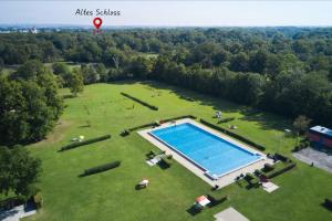 an aerial view of a large field with a swimming pool at Altes Schloss - Boutique Ferienwohnung in Laxenburg