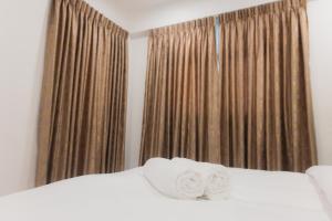 a bedroom with a bed with two towels on it at Comfy Quite Private Room with Private Balcony - Hulhumale in Hulhumale