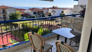 a balcony with a table and chairs and a view at LAINAS apartments in Nea Skioni