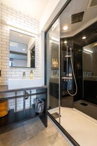a bathroom with a sink and a shower at HOTEL TABARD TOKYO in Tokyo +49 photos