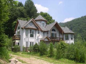 a house in the middle of a field at Happy Dream Pension in Pyeongchang