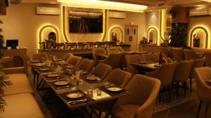a dining room with long tables and chairs at Achyutam By IKA Hotels in Bhuteshwar