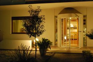 a front door of a house with a plant at B&B Villa Bianca in Sona