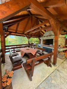a large wooden pavilion with a table and chairs at Lahor in Bihać