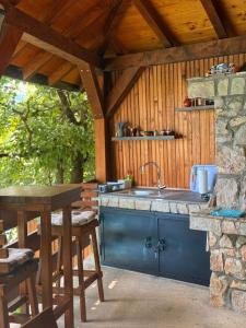 an outdoor kitchen with a sink and a stone wall at Lahor in Bihać