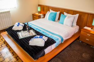 a bedroom with a bed with a tray of towels at Escondidinho do Vez, LDA in Arcos de Valdevez