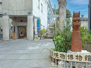 a building with a street with a statue in front of it at TATAMI NO YADO Naha Tsuboya by Coldio Premium in Naha +15 photos