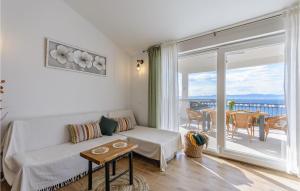 a living room with a couch and a balcony at Nice Home In Splitska-Supetar With Wifi in Splitska