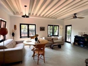 a living room with a couch and a table at Dock Cottage House in Bădeni