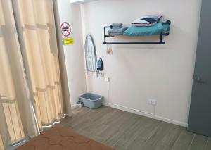 a room with a bed on a shelf on the wall at C&S BaySuites Homestay in Kota Kinabalu