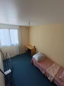 a bedroom with a bed and a desk in it at Beautiful private room in apartment in Saint-Pierre-des-Corps