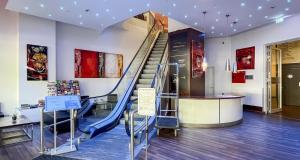 a staircase in a building with a blue slide at Best Western Plus Plaza Berlin Kurfürstendamm in Berlin