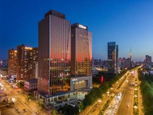 a city skyline with tall buildings and street lights at Hilton Harbin Exhibition Center in Harbin