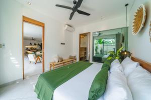 a bedroom with a large bed with green and white pillows at Stylish 2bedroom Villa Canggu Padonan in Kerobokan +20 photos