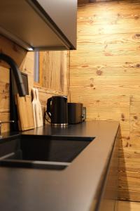 a kitchen with a sink and a counter top at Leos Chalet in Valdaora di Sopra +54 photos