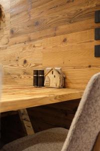 a wooden table with a bird house on it at Leos Chalet in Valdaora di Sopra +53 photos