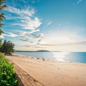 a group of people walking on a beach at Phan Nguyên Mandala Mũi Né in Mui Ne