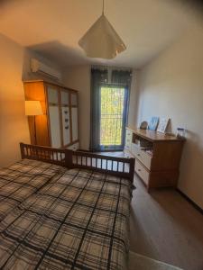 a bedroom with a bed and a desk and a window at Marina Cape Sky View Lux Apartment in Aheloy in Aheloy