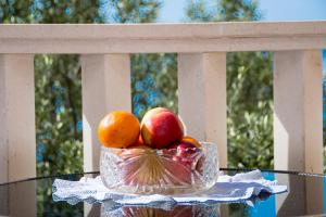a bowl of fruit on a table on a balcony at Vila Tatinja in Trogir