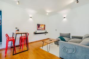 a living room with red stools and a couch at Chique 1BR Villa with Lush Garden Nakuru Town in Nakuru