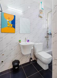 a white bathroom with a toilet and a sink at Chique 1BR Villa with Lush Garden Nakuru Town in Nakuru +12 photos