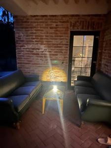 a room with couches and a table with a light at Dock Cottage House in Bădeni +9 photos