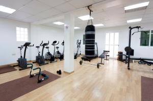 a gym with several treadmills and exercise bikes at Hotel Riutort in El Arenal