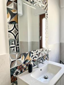 a bathroom with a sink and a mirror at Palazzo Galante in Ginosa Marina +29 photos